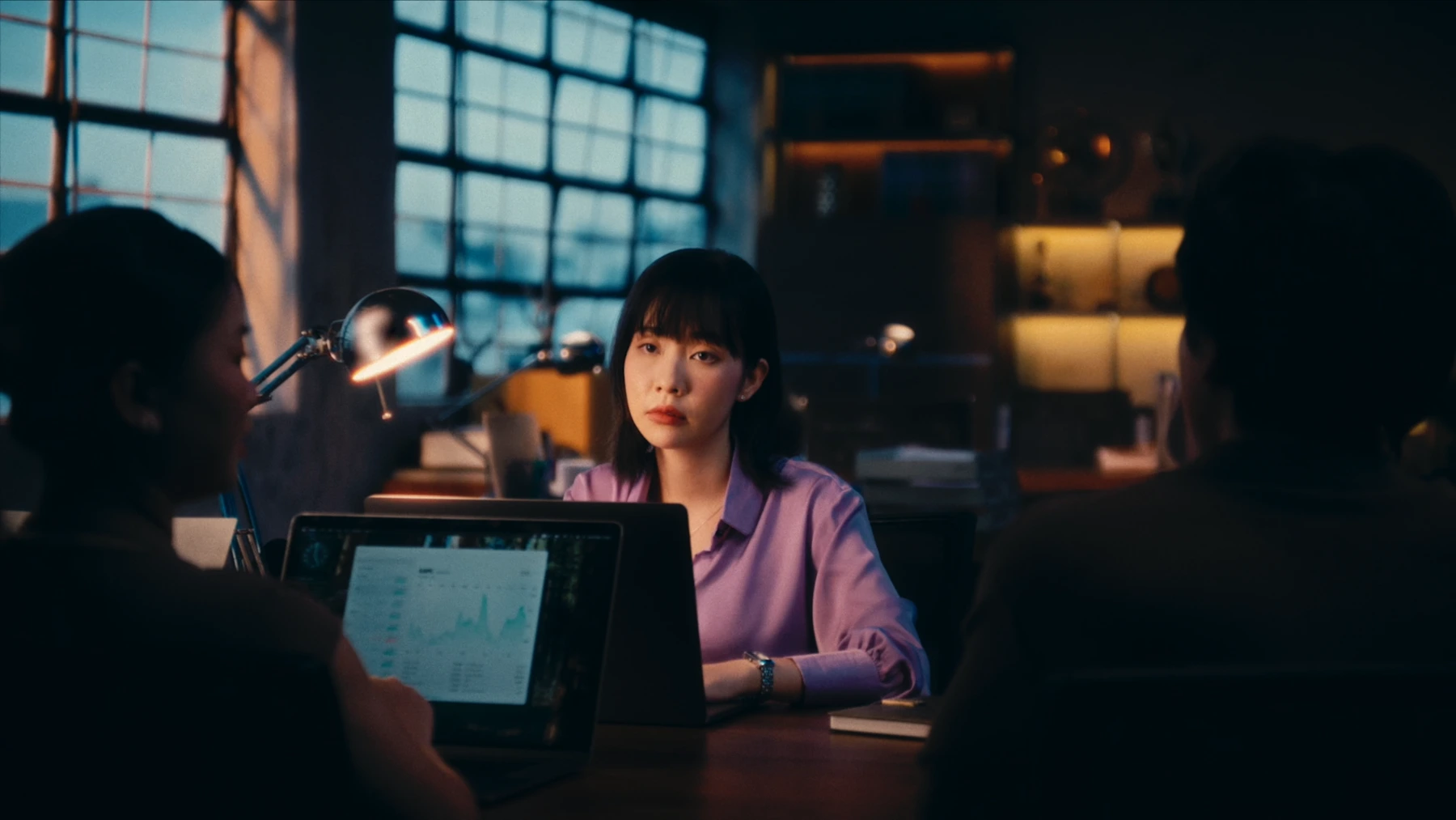Woman in a violet shirt in an office