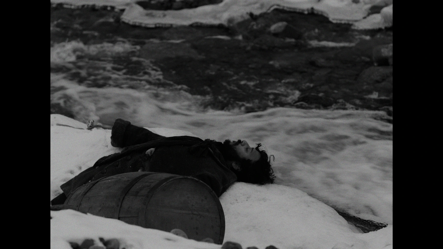 Monochrome figure lying in snow
